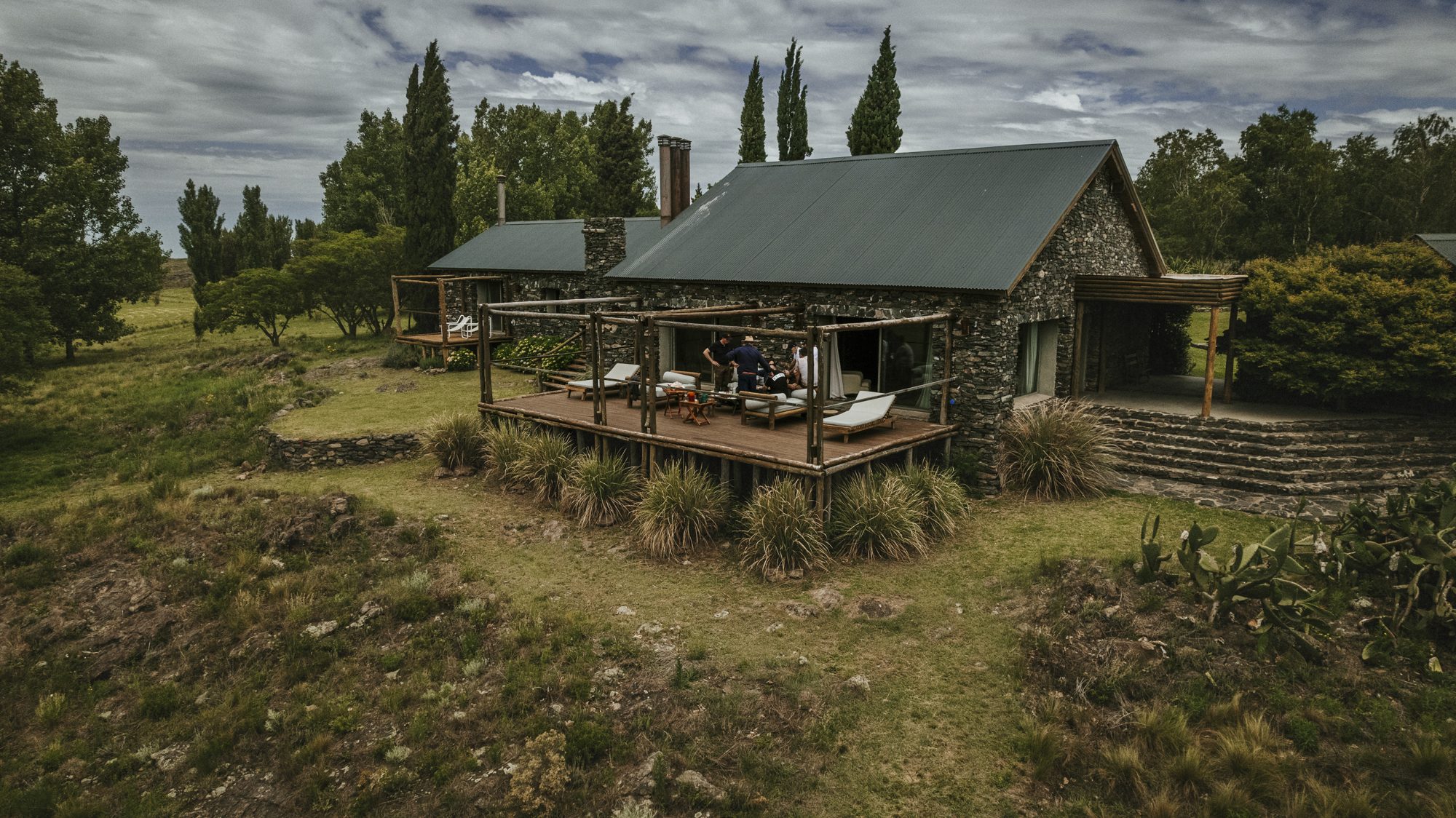 La casa de piedra con su deck, vista desde el campo
