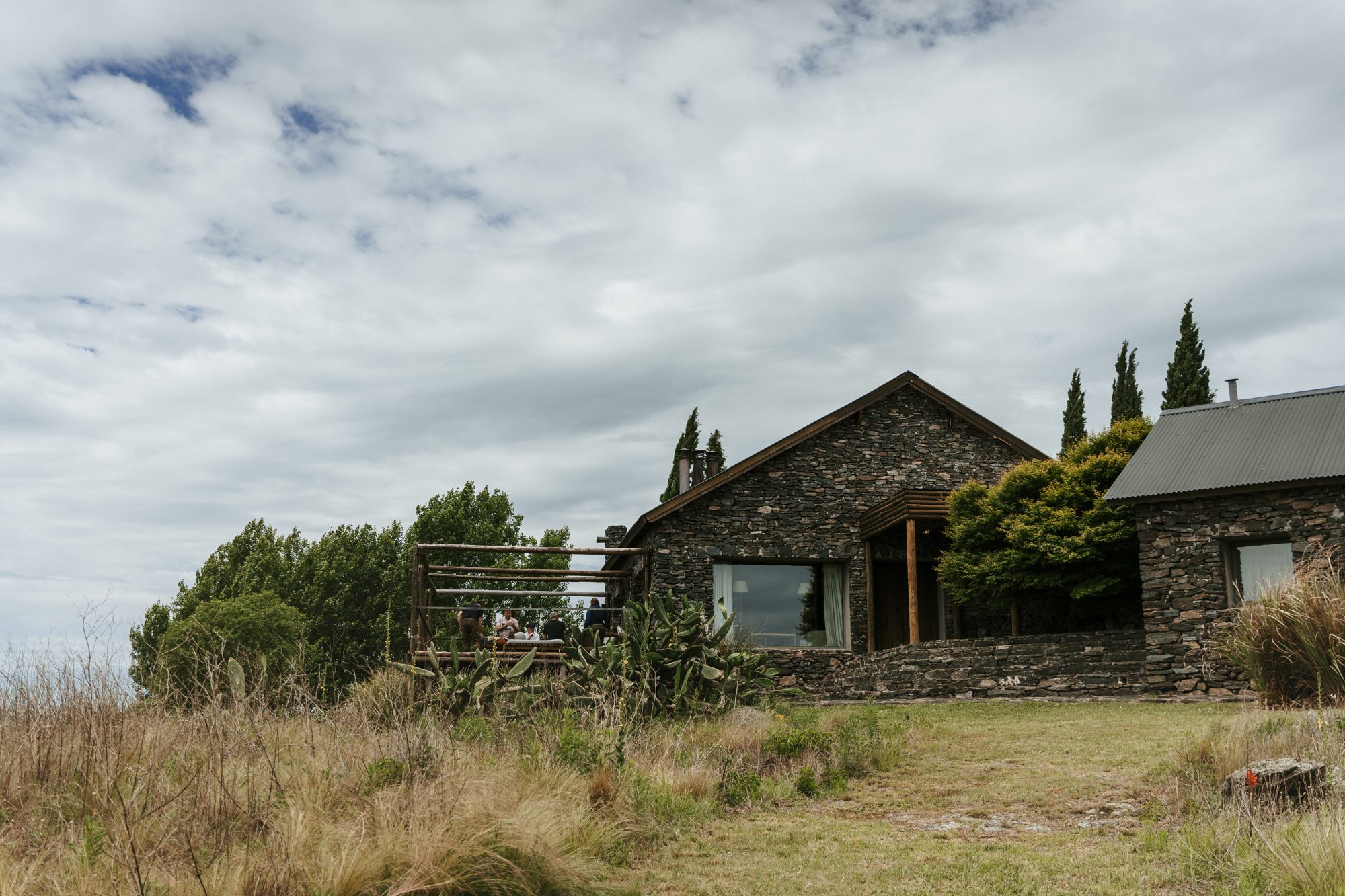 Stone facade and cypresses