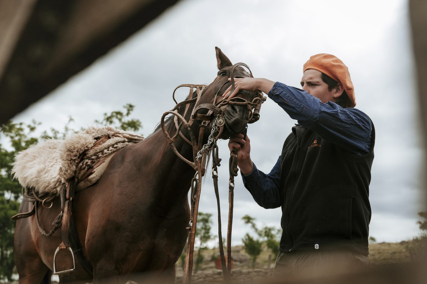 Lucas saddles a horse before the ride