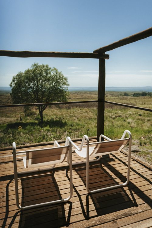 Chairs on the deck under the tree at teatime