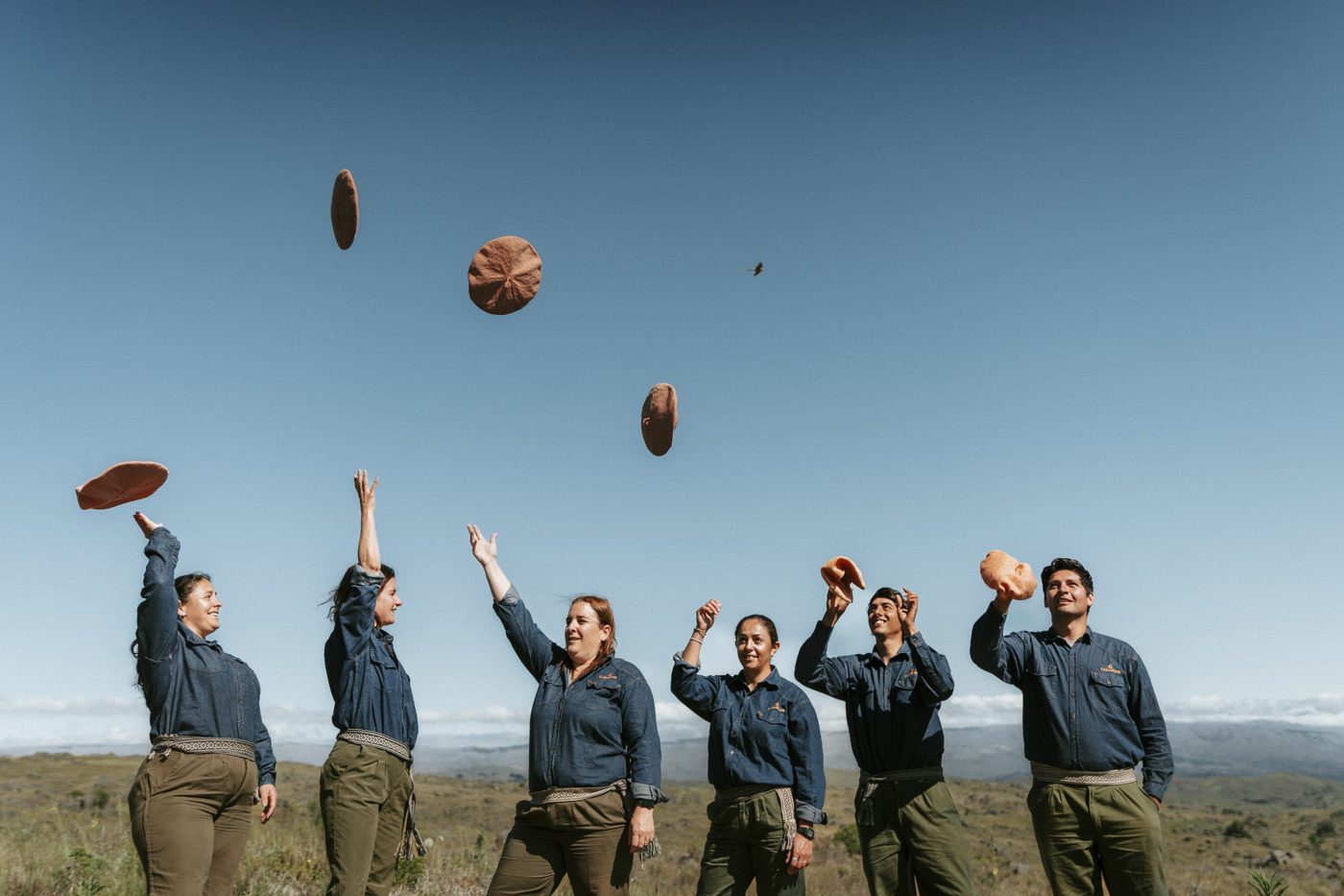 The Carahuasi team throwing their berets in the air